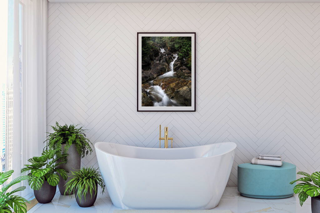 Waterfall art work hung on wall over bathtub
